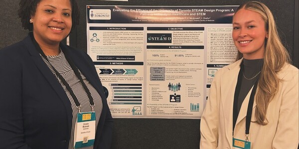 Coordinators presenting a poster at a conference