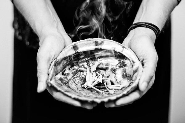 smuding sage in a bowl