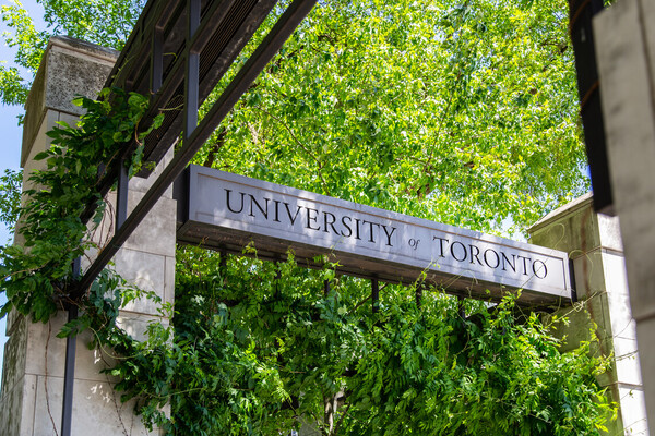 Sign surrounded trees saying University of Toronto