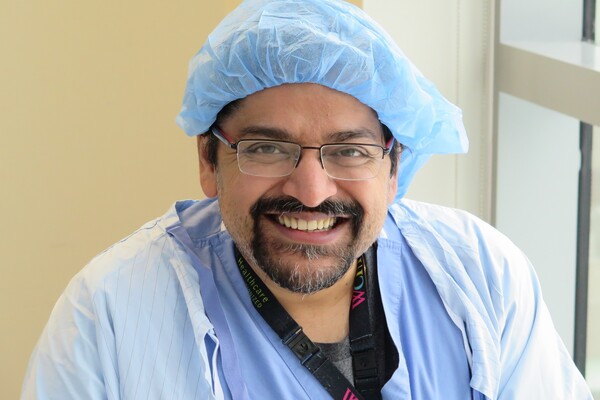 head and shoulders of man in surgical gown
