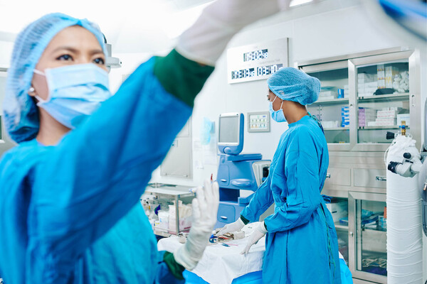 Surgical team preparing operating theater for upcoming surgery