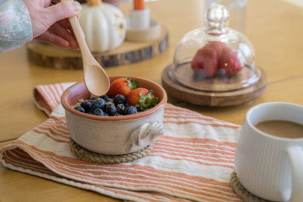 A bowl of oatmeal topped with berries.