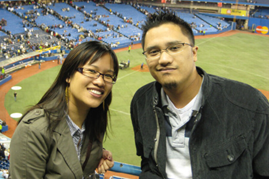 Cherrie-Marie Chiu poses with her brother Christopher in front of a baseball field. Cherrie and Christopher started ALS Double Play to benefit ALS research at the University of Toronto after Christopher's diagnosis