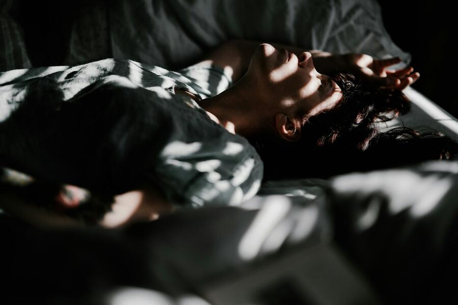 Woman at night, light in bedroom