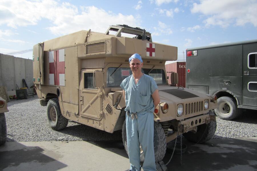 Dr. Andrew Beckett at Kandahar Airfield in front of Humvee ambulance