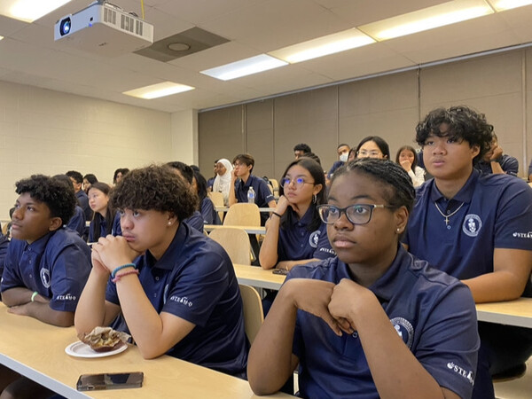 Students seated in a lecture hall.