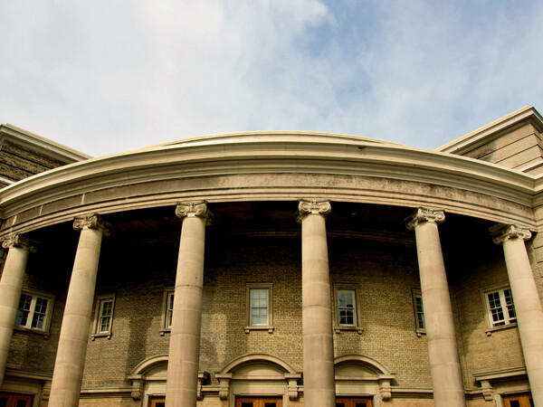 Convocation Hall's roofline on a partly cloudy day. 