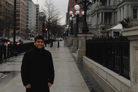 Medical student Ali Damji in front of the Eisenhower Executive Office Building in Washington DC