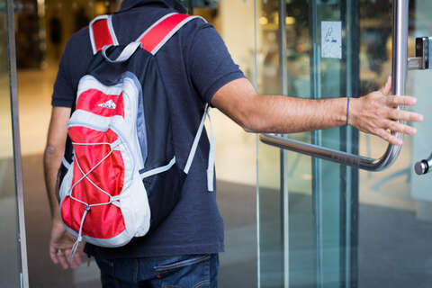 Male wearing red backpack
