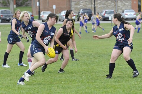 Rochelle Allan (with the ball) playing Australian Rules Football as a member of the Central Blues AFC (Credit: Rob Colburn, OAFL Photos).