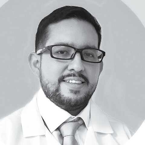 a black and white photo of a researcher in a lab coat