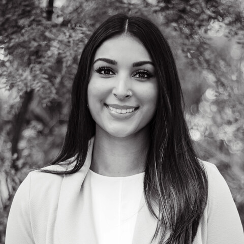 A black and white photo of a researcher with long dark hair