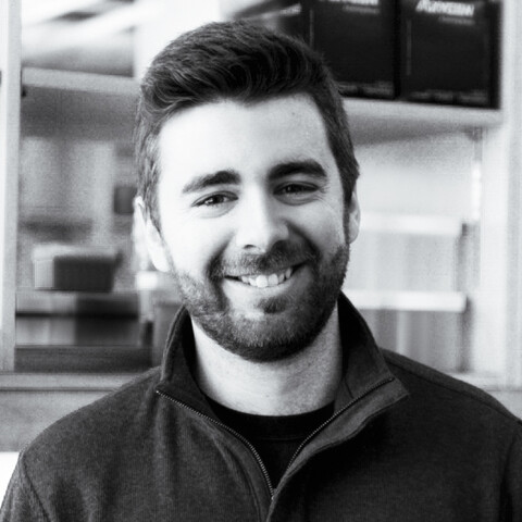 A black and white photo of a researcher with a beard