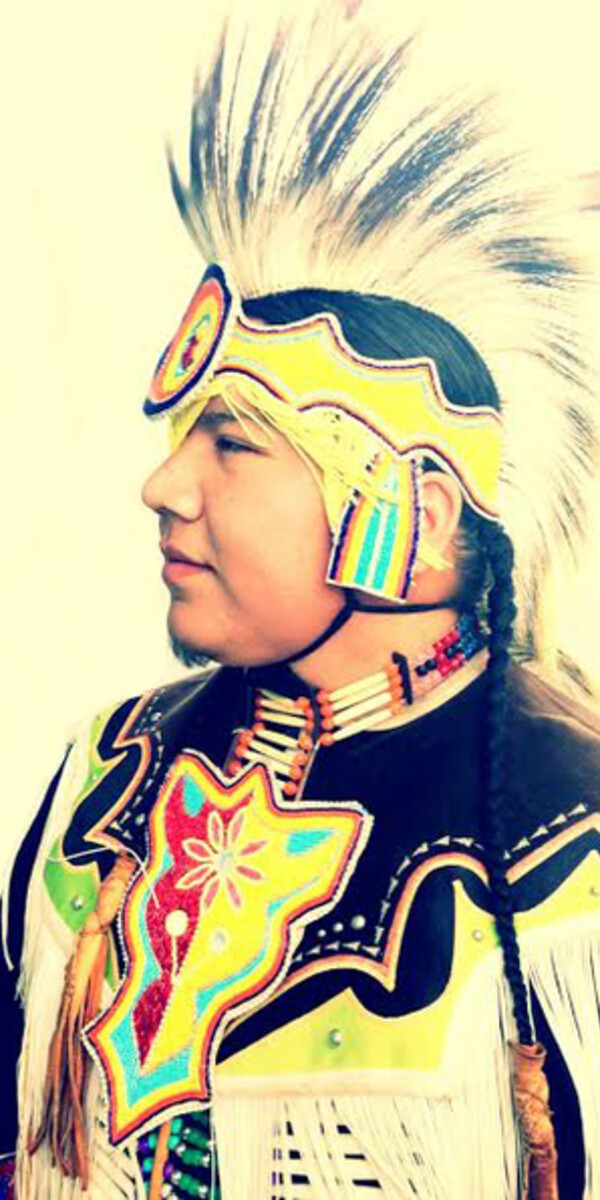 profile view of Indigenous man in regalia