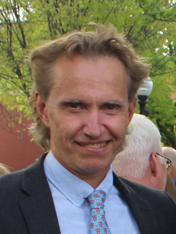 Martin Ingelsson has blond curly hair and is wearing a light blue shirt with a navy jacket.