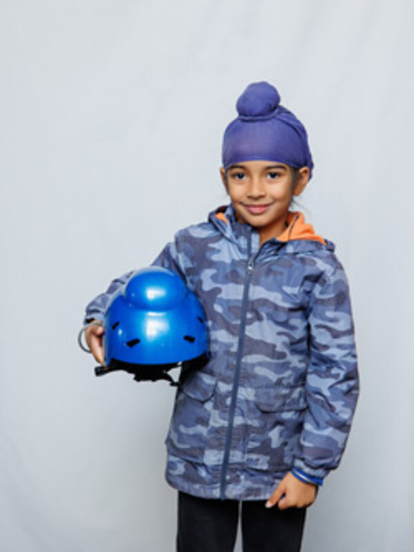 A child holds one of helmets Singh designed