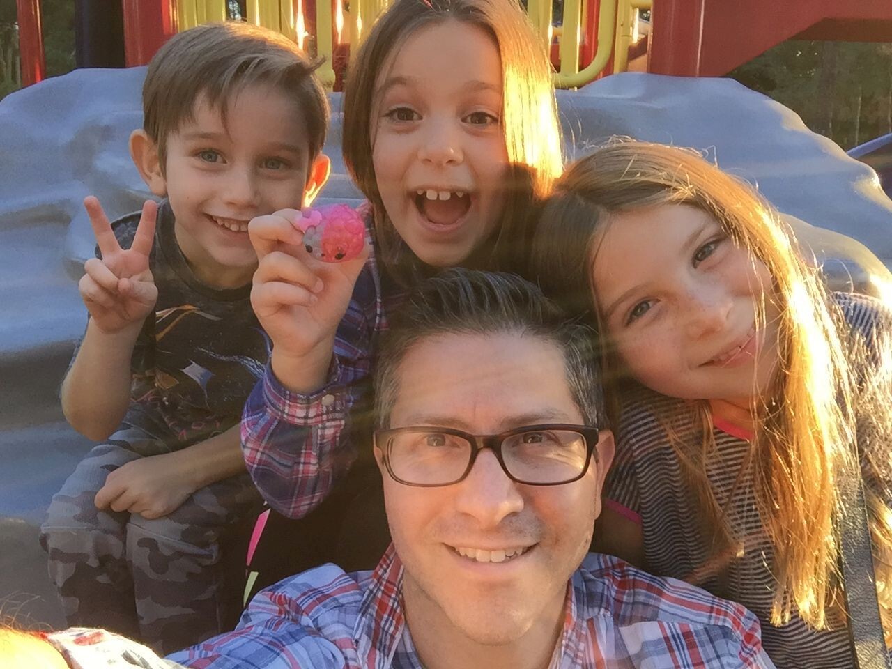 Photo of the alumnus with his three children.