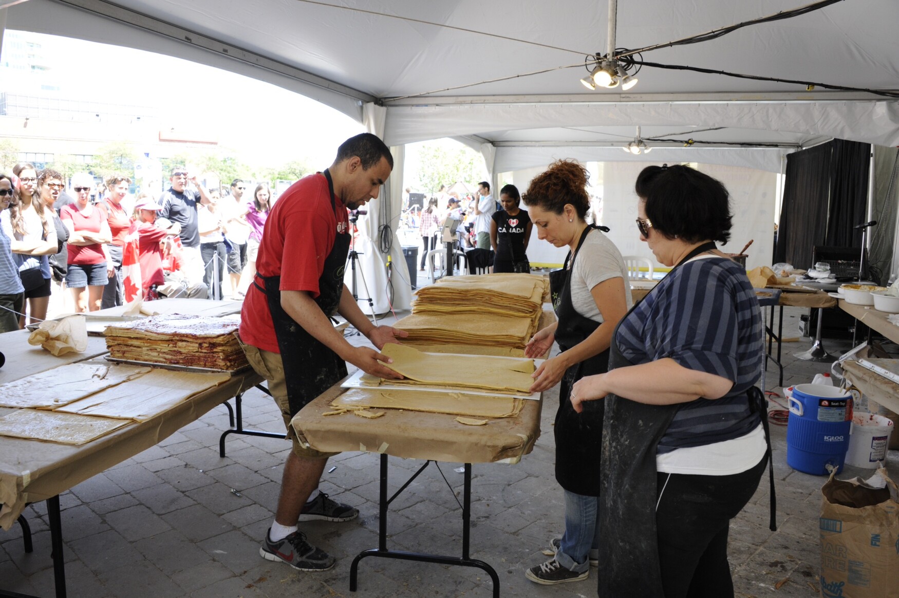 U of T employee Ike Okafor, on the left, takes part in a World Record challenge for the “Most Layers in a Layer Cake.”