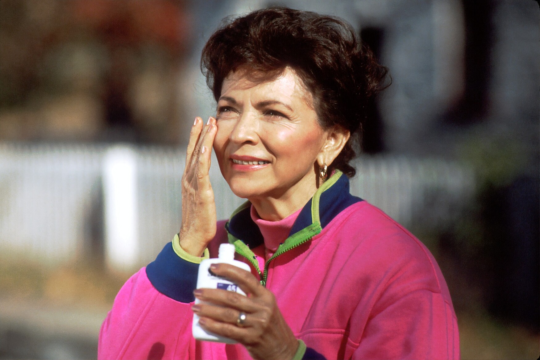 Woman applies sunscreen