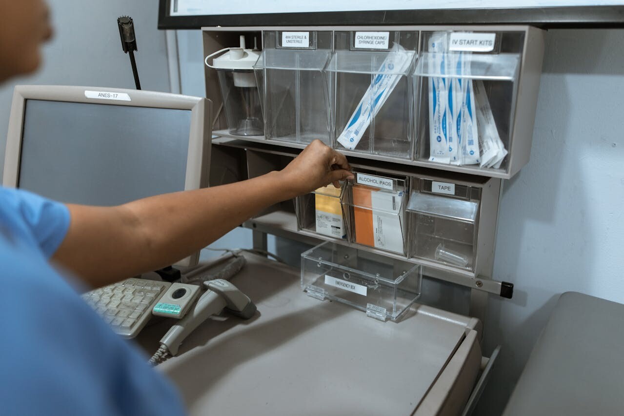 Over the shoulder view of medical professional reaching for item on a shelf