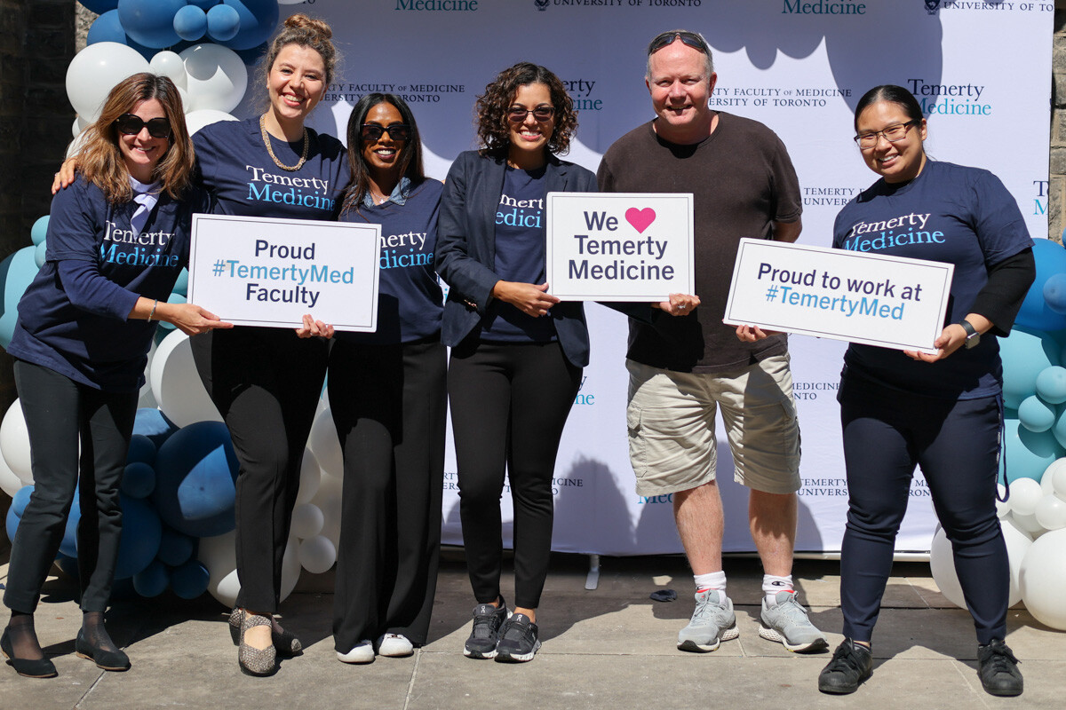 Photo: staff at bbq with signs "Proud to work at Temerty Medicine"