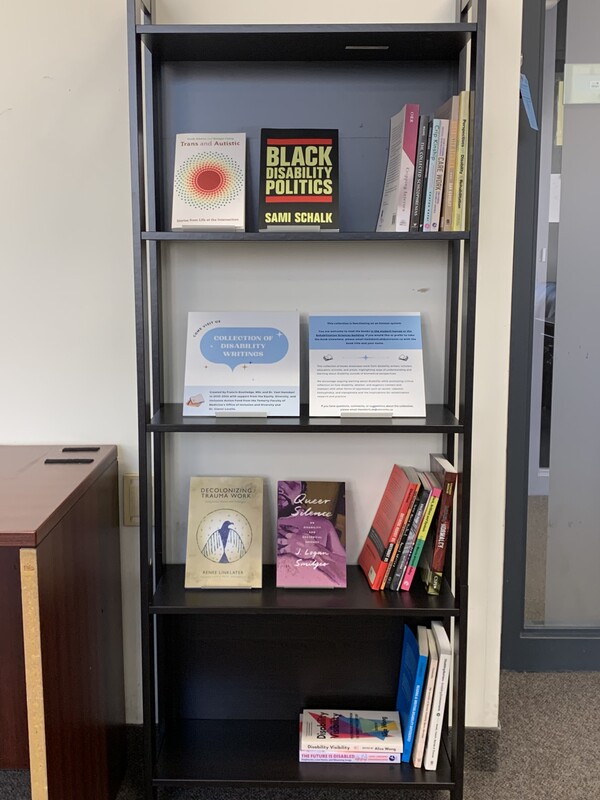 A tall bookshelf with books from the Disability Book Collection arranged in it.