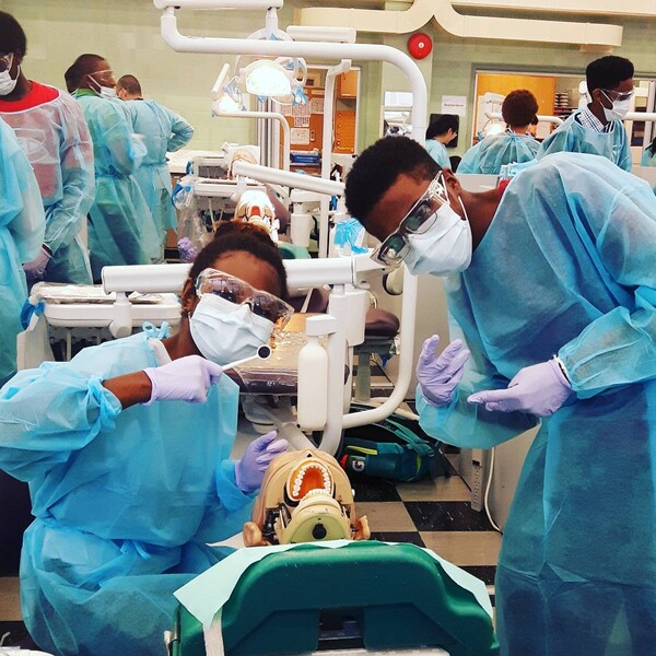 Two students participate in a Summer Mentorship Program dentistry session. 