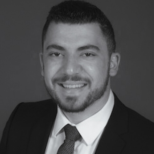 a black and white portrait of a researcher in a suit and tie