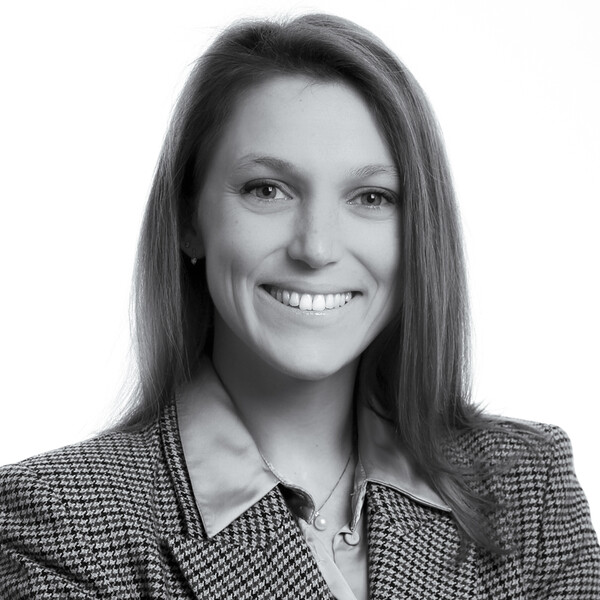 a black and white portrait of a researcher in a houndstooth jacket