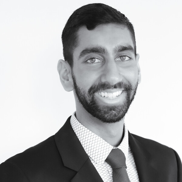a black and white portrait of a researcher in a suit and tie