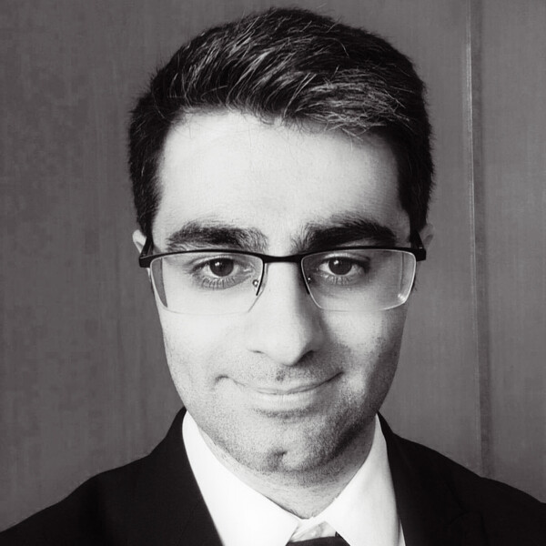 a black and white portrait of a researcher in a suit and tie