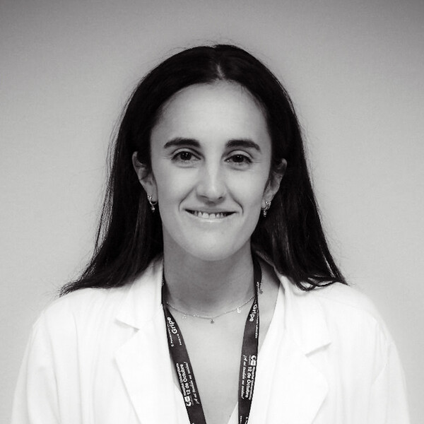 a black and white portrait of a researcher in a white lab coat