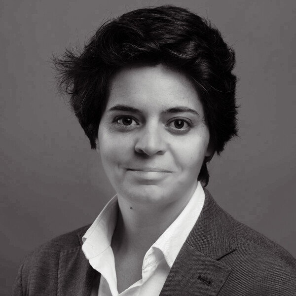 a black and white portrait in a collared shirt and jacket