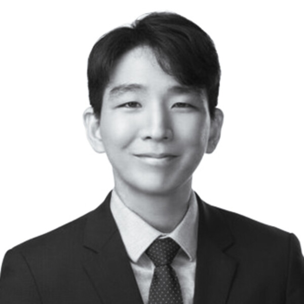 a black and white portrait of a researcher in a suit and tie