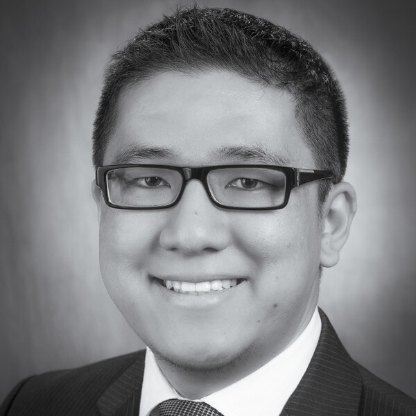 a black and white portrait of a researcher in a suit and tie