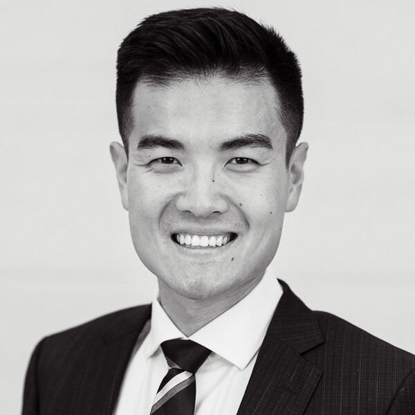 a black and white portrait of a researcher in a suit and tie