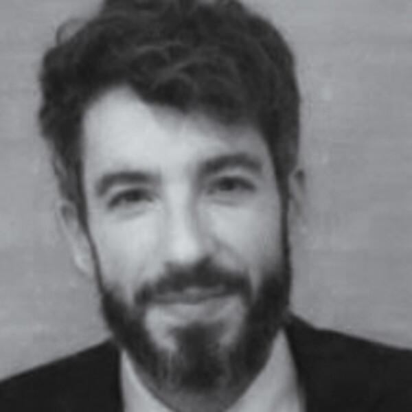 a black and white portrait of a researcher in a jacket with a beard