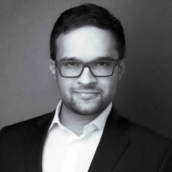 a black and white portrait of a researcher in a jacket and collared shirt