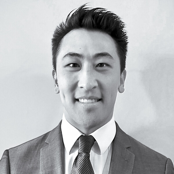 a black and white portrait of a researcher in a suit and tie