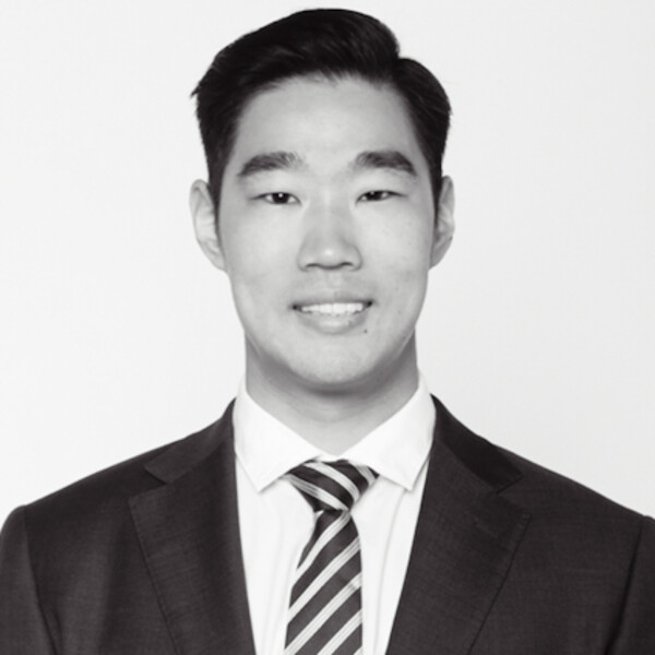 a black and white portrait of a researcher in a suit and tie