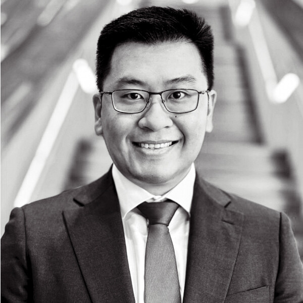 a black and white portrait of a researcher in a suit and tie