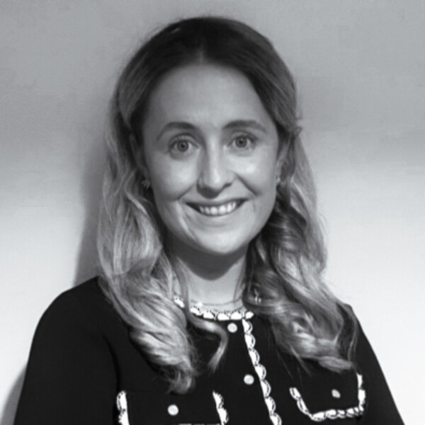a black and white portrait of a researcher with light curly hair