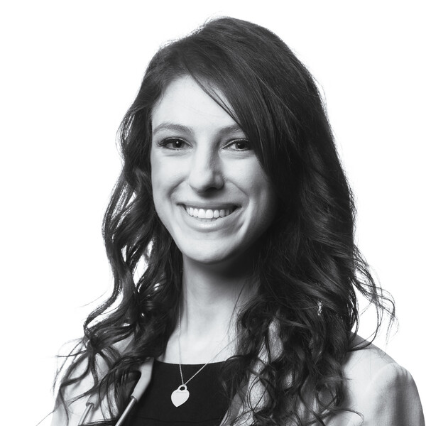 a black and white portrait of a researcher with long curly dark hair