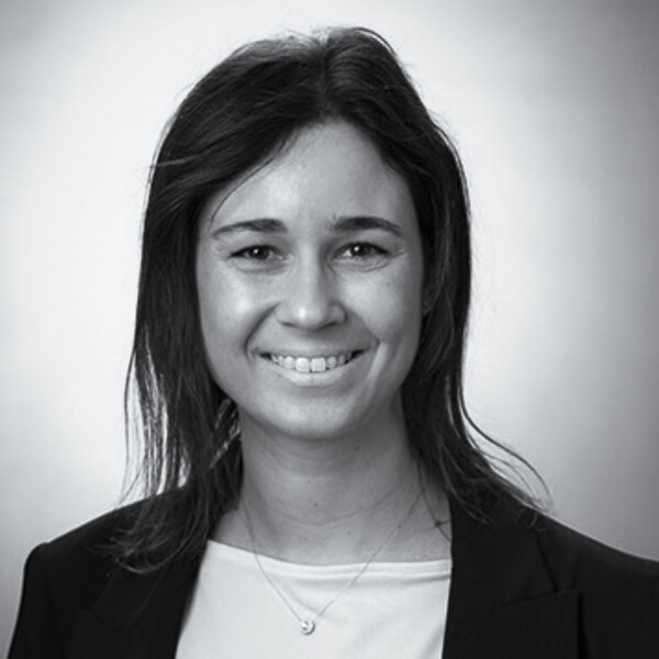 a black and white portrait of a researcher wearing a dark jacket