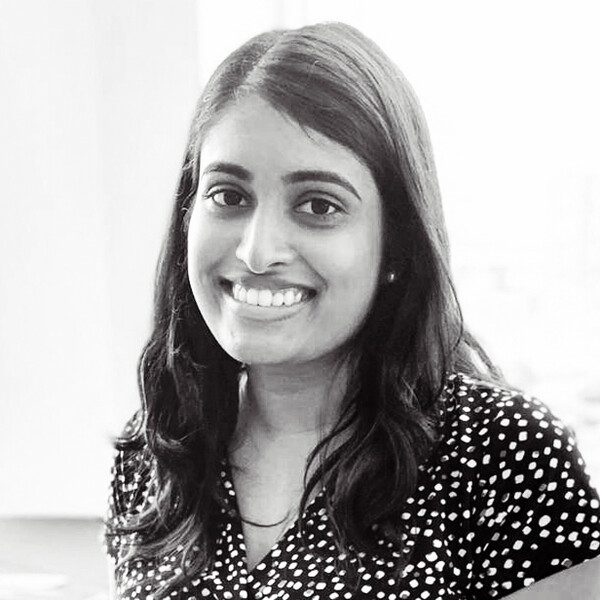 a black and white portrait of a researcher wearing a polka-dot shirt