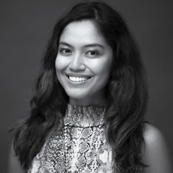 A black and white photo of a scientist with long dark hair