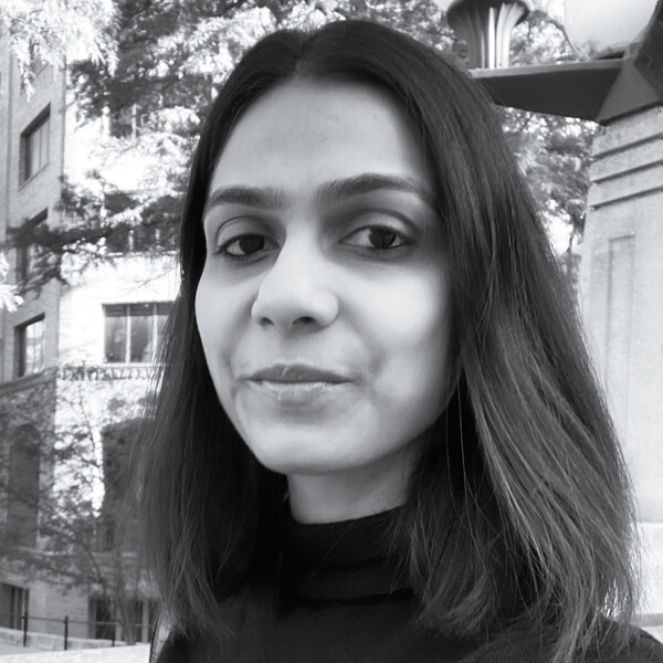 A black and white photo of a researcher with shoulder-length dark hair