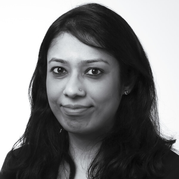 a black and white photo of a researcher with long wavy dark hair