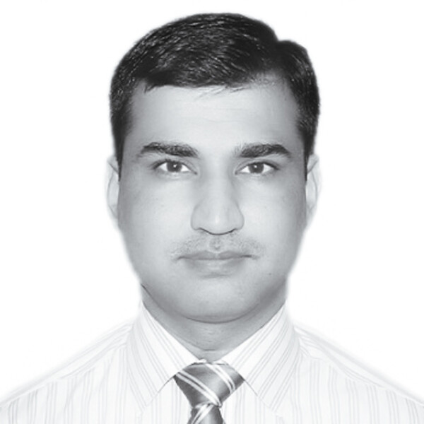 A black and white photo of a researcher in a striped shirt and tie