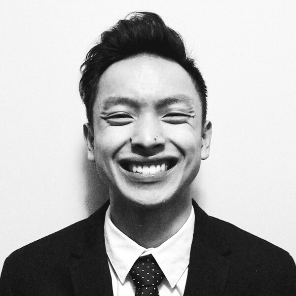 A black and white photo of a researcher in a black jacket and tie
